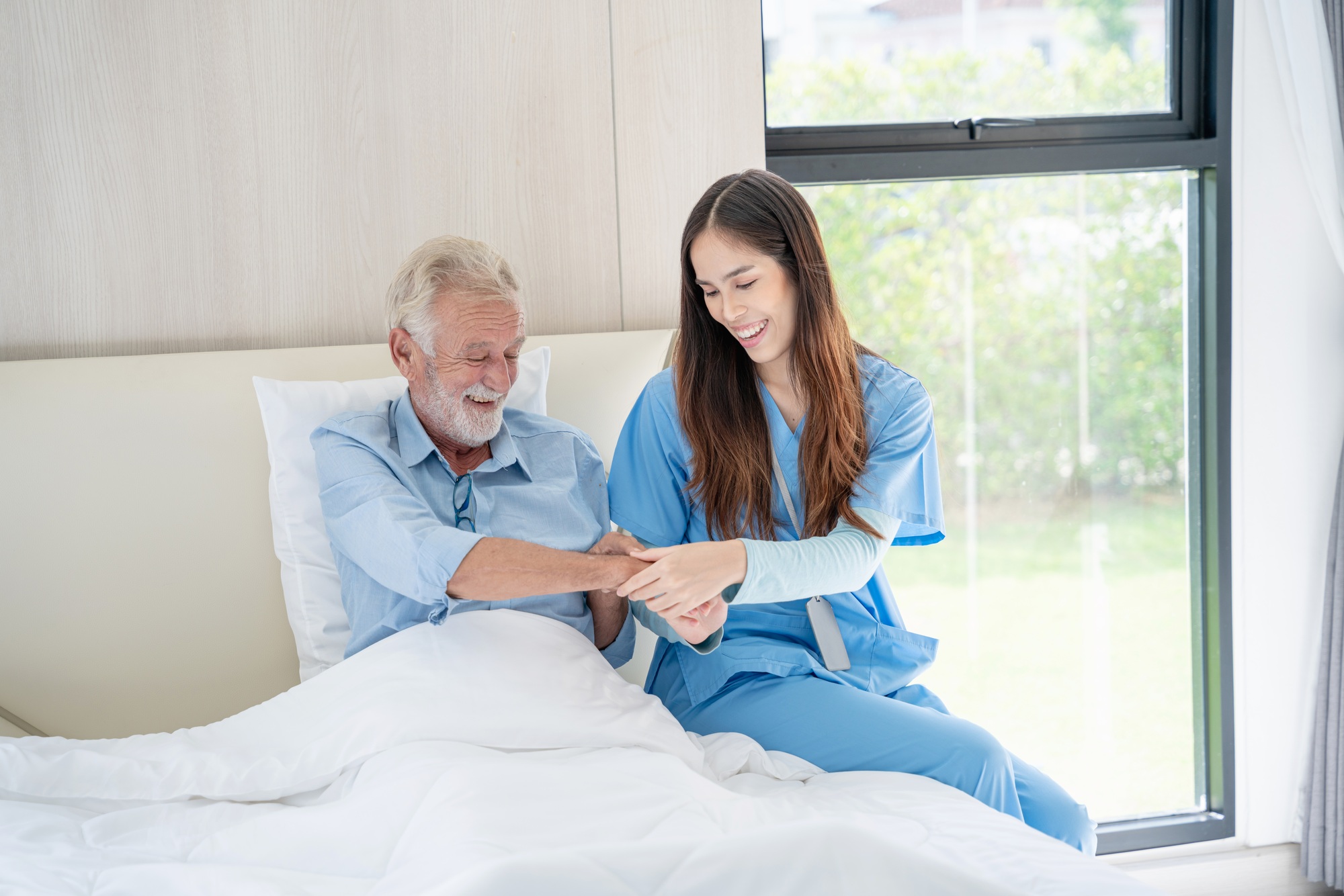 Medical staff taking and caregiver senior man in Home. Home care concept.